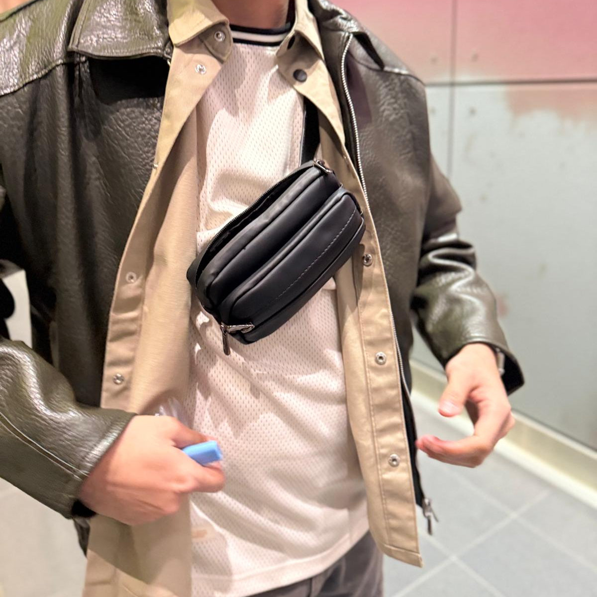 Man carrying the High Goods smell-proof crossbody bag over a light jacket
